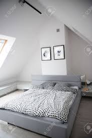 Maybe you would like to learn more about one of these? Modern Monochrome Design Home Interior Of Bedroom Room In Mansard With Wooden Bed And Elegant Accessories Stylish Home Decor With Mock Up Abstract Paintings On The Wall Stock Photo Picture And Royalty