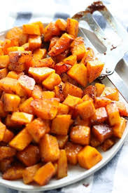 Roasted Butternut Squash Brown Sugar Shown Baked In Cubes On A White Plate With A Meta Butternut Squash Recipes Butternut Squash Recipes Roasted Squash Recipes