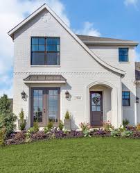 Black And White Painted Brick House Tudor Home White Painted Brick Tudor Bronze Windows Does It Get Any Better Clarity Homes Painted Brick House Tudor House Exterior Tudor Style Homes