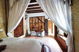 Unique Experience In Seville Sevilla Spain Rustic Old Style Bedroom With Antique Vibes And De Wooden Dining Room Chairs House Restoration Wood Beam Ceiling