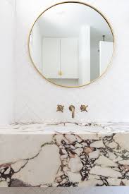 Small herringbone marble floor tile s are placed under a glass and marble washstand fitted with a white porcelain sink and a polished nickel faucet mounted in front of a white subway tile backsplash lined with white pencil. Pattern Play Herringbone Tile Is Here To Stay Fireclay Tile