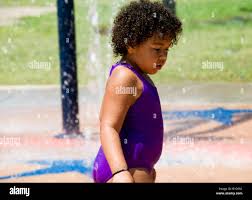 A 3 to 4 year old overweight African-American toddler takes a moment of  rest at a water park Stock Photo - Alamy