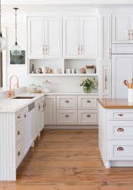 A separate, yet inclusive, bar area provides countless amenities to make entertaining a breeze, and the large center island creates a natural gathering space for friends and family alike. St Louis Off White Kitchens Farmhouse Kitchen With Kitchen Island Wood Top And Cabinetry