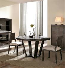 It is mounted on crossed legs made of wood. Contemporary Round Dining Table