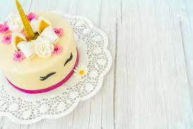 This cake is pure magic, plain and simple! Unicorn Cake On A Wooden Background And Lace Cute Unicorn Layered Homemade Cake Decorated With Bow Rose Flowers Golden Corn And Ears Copy Space Stock Photo Picture And Royalty Free Image Image