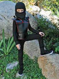 He wears a navy blue full body suit with a navy blue ninja hood on his head and silver bracelets on both wrists. Easy Diy Ninja Costume For Kids Hgtv