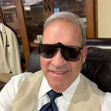 I found this hanging from the basement rafters of my 100 year old house. It  appears to be two marbles or something similar in a hanger of some sort.  Any one have