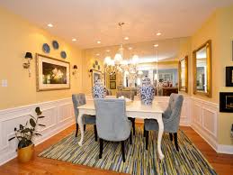 Photo courtesy of marvin® windows and doors. Pale Yellow Dining Room With Mirrored Wall And Blue Chairs Hgtv