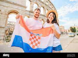 happy beautiful couple in front of coliseum in Pula Croatia with croatian  flag. travel concept Stock Photo - Alamy