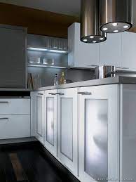 Island with glass door end caps. A Contemporary Two Tone Kitchen Under A Loft Glass Kitchen Cabinets Kitchen Design Modern Kitchen