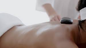 Premium stock video - Woman receiving a massage with hot stone