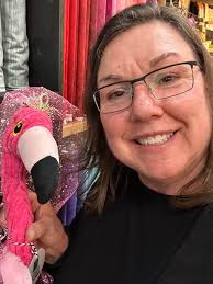 My fireplace flamingos. Lol The tall wooden one came from the Kumquat  Festival in Dade City FL many years ago. The other two are from Hobby  Lobby.