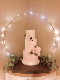 Embroidery hoops with your wedding date and names can become a great wedding favor for all the guests. Cake Hoop Stand Please Note Hoop And Base Sold Separately Made With Reclaimed Recycled Rustic Timber Please Read Listing Info Wedding Cake Display Wedding Centerpieces Wedding Cake Table