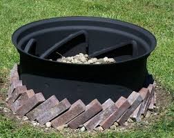 Our Homemade Fire Pit An Old Re Painted Tractor Tire Rim Painted With Rustoleum High Heat Paint Filled With Outside Fire Pits Homemade Fire Pit Fire Pit