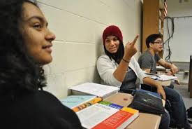 TIPS FOR A TUTOR: Aghilah Nadaraj, Students for Education vice president  and senior, gestures as she explains the club's work to senior Shreeya  Raman. Nadaraj said newer members like Raman have been