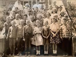 This photo is from 1949. It is our cousin Eddie McCarley's first grade  picture. We noticed what looks like our uncle Jimmy Holley in this picture.  Anyone know who the young lady/teacher