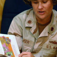 U.S. Navy CAPT. Kevin Hutcheson, Combined Joint Task Force-Horn of Africa  (CJTF-HOA) deputy political advisor, shares a moment with children who are  living in a tent city set up by CJTF-HOA after