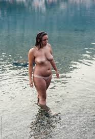 Young Naked Woman Getting Out Of The Water