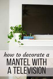 Garland is your best friend. 7 Tips For Decorating A Mantel With A Television Love Renovations