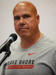 Justin Newcomb, right, is the new coach at Cousino…