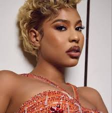 UMFAZI WAKWA ZULU . PROLOGUE . She steps outside with a bowl filled with  corn ready to feed the chickens ‚ she walks around calling the chickens ‚  they gather around as