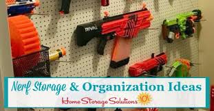 This stylish black and orange nerf storage rack has space for up to 20 blasters, plus shelving, and a drawer for tons of darts and accessories! Nerf Storage Organization Ideas For Blasters Accessories