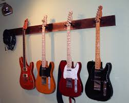 I used this type of wall hanger to hang my guitar when i was a teenager and it still holds perfectly fine fifteen years later: Guitar Wall Hanger 4 Steps With Pictures Instructables