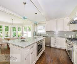 As you can see, there's some amount of lights come into the kitchen to let the white scheme shine brighter. Off White L Shaped Kitchen Design With Island Decora