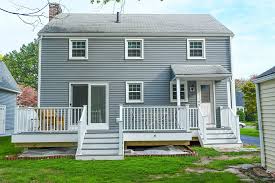 Large red brick victorian home with central tower among trees on a large property. Deck Installation Deck Repairs Zn Construction Canton
