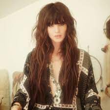 Wavy hairstyles are a dime a dozen, but this one is set apart by its fluffy bangs and rich chocolate color. 50 Extraordinary Ways To Rock Long Hair With Bangs Hair Motive