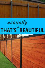 We have some easy diy fence tutorials for you to try! Build A Wood Fence With Metal Posts That S Actually Beautiful Wood Fence Design Wood Privacy Fence Wood Fence