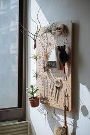 amabro 日本 的洞洞板 peg board 木頭的板子 比一般給人工業風印象的金屬沖孔板 要秀氣一點 裝在我的工作區 放上常用的工具和空氣鳳梨 遠看像標本展示 house interior decor mens bedroom decor decor