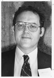 Robert E. McIntosh and Calvin T. Swift, standing indoors next to equipment 