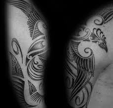 The bold lines blend with the natural grace of a wolf, to create magnificent usually dense shades of blue, brown, or black feature in wolf tribal tattoos. Unique Shaded Male Phoenix Arm And Shoulder Tribal Tattoo Designs Phoenix Tattoo Design Tattoo Designs Men Tribal Tattoos