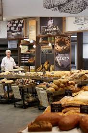 tiers of freshly baked artisanal style bread recreate the traditional bakery experience bread shop bakery design bakery shop design