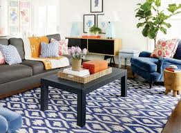 Decorate your space with a soothing and warm blue rug from rugs usa. Grey Couch With Navy Graphic Rug Blue Chairs Pops Of Orange Black Coffee Tabl