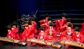A female korean shaman (mudang) may use many combinations of musical instruments. Talk Talk Korea
