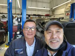 Dan Karl and Stephen Pickney with the #71 tribute car to Daniel Karl 's  father. Next to it is a car owned by Jeff Ciglich and driven by Aaron Pugh