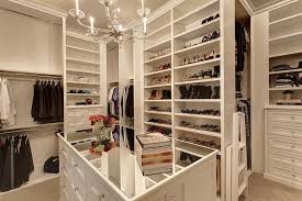 How many drawers are in a walk in closet? Mirrored Top Closet Island With Glass Chandelier Transitional Closet