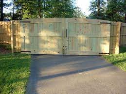Time to replace the double hinged driveway gates with a single sliding gate. Gates To Span The Entire Driveway 16 Wide 6 6 High And 3 Thick It Was Actually Harder To Make These O Wood Gate Driveway Gate Diy Entrance Gates Driveway