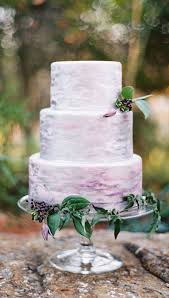 Pretty lilac flowers on white wedding cake . Lavender And Lilac Wedding Colours For Romantic Brides
