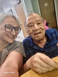 Elderly lady compliments young mailman's outfit