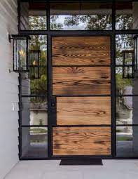 Such doors remind of fortresses and look awesome keeping your privacy with that large metal part. Stunning Glass Front Doors Ideas To Connect Indoors With Outdoors