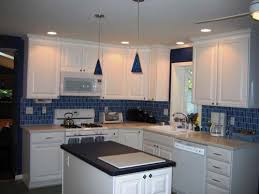 white cabinets and blue backsplash