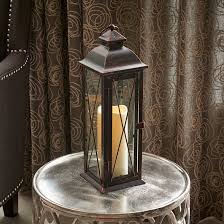 Propped up on a gold metal tripod base. Charlton Home 18 Metal Floor Lantern With Candle Reviews Wayfair