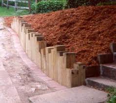Because building terraces is labor intensive, it may be better to spread the project over several years or hire a professional. Retaining Walls Timber Vertical Timbers Sloped Garden Garden Retaining Wall Landscape Timber Ideas