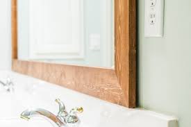 This rustic mirror frame works well with farmhouse decor (i.e. How To Diy Upgrade Your Bathroom Mirror With A Stained Wood Frame Building Our Rez
