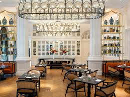 The steamer trunk bar in the parlor opens up to reveal a nespresso coffee capsule machine, wine glasses, additional bottled water, . Hotel Em Singapore Raffles Singapore All