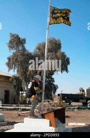 U.S. Army Capt. Lyle Gardner of Boswell, Penn., a company commander in the  1st Battalion, 110th Regiment, 28th Infantry Division, raises a Pittsburgh  Steelers flag at an American military base in Habaniyah, 80 kilometers (50  miles) west of Baghdad, Iraq ...
