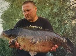 The man himself, Ted Bryan, our head bailiff, with Floppy Tail from  Johnson's Railway Lake back in the 90's. https://swsfisheries.co.uk